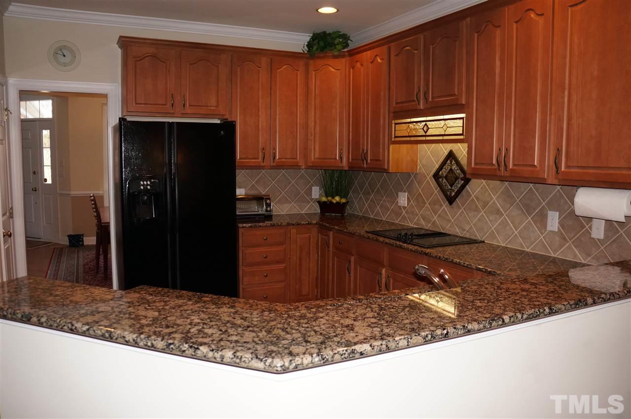 10913 Clovermill Circle Raleigh, NC 27617 - Photo 9 of 25 The breakfast bar seperates the kitchen area from the family room and breakfast room! Great area to entertain!