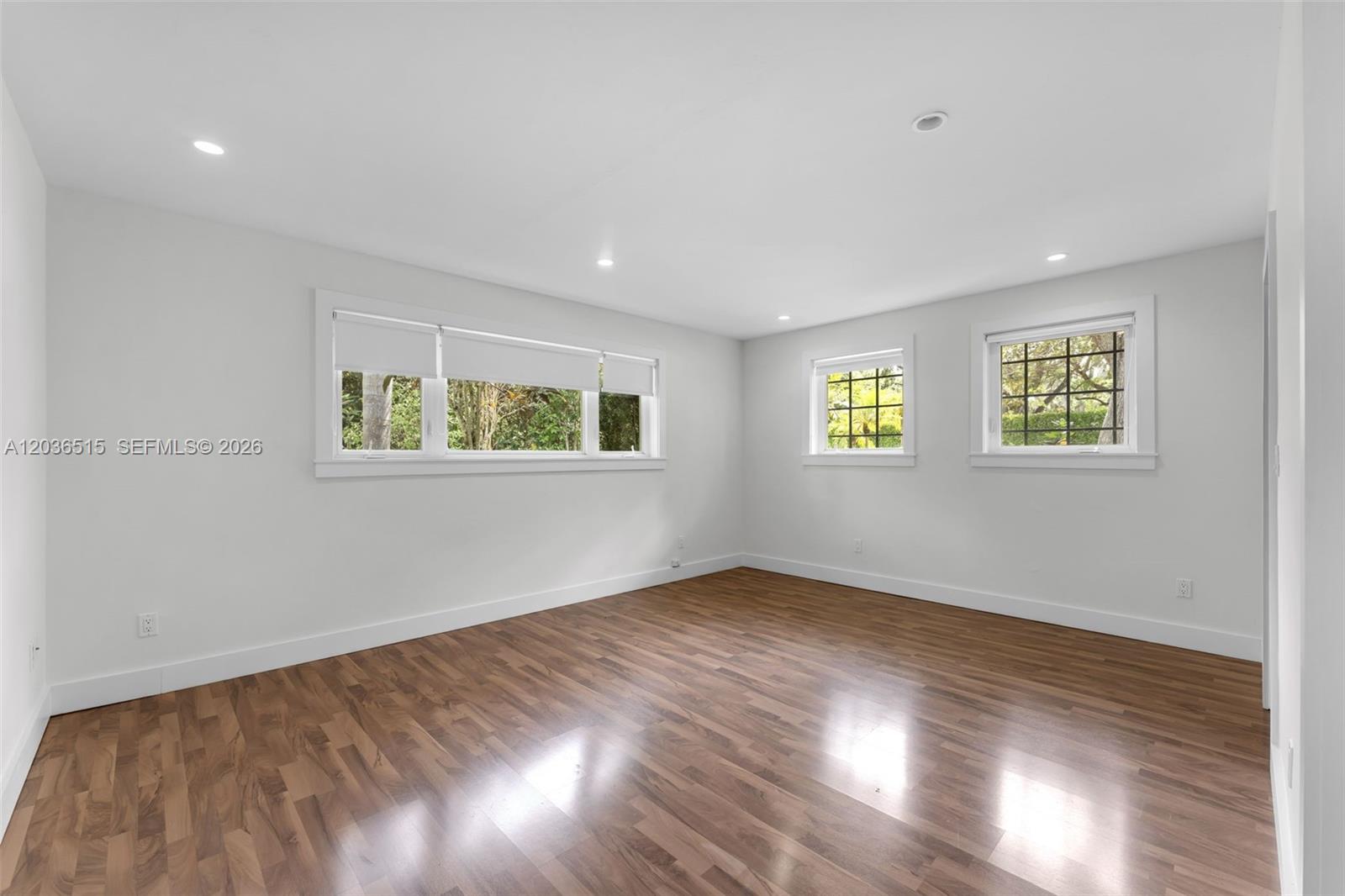7711 Erwin Road Coral Gables, FL 33143 - Photo 19 of 26 a view of an empty room with wooden floor and a window