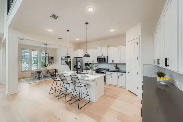 a kitchen with sink cabinets and living room view