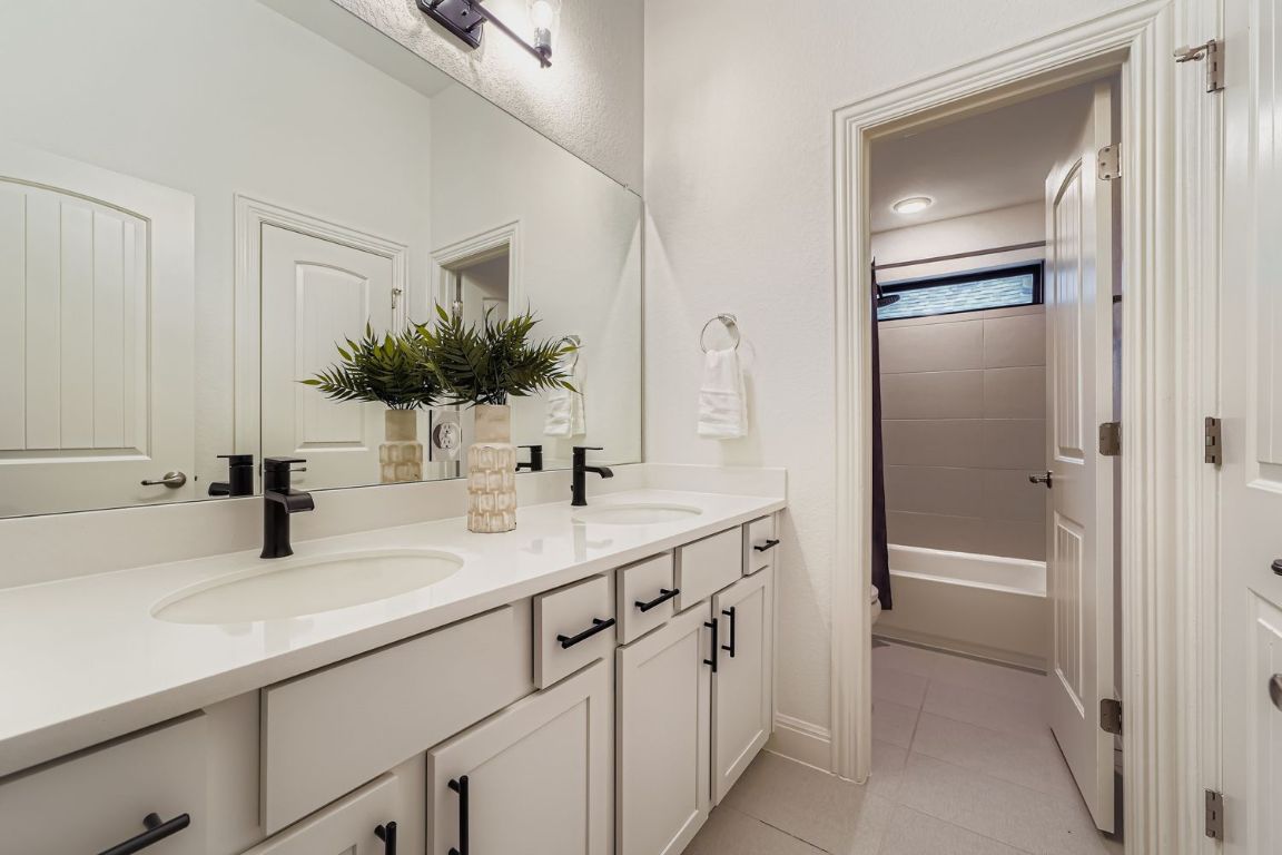 2928 Birdcall Path Leander, TX 78641 - Photo 24 of 36 a bathroom with a sink and a mirror