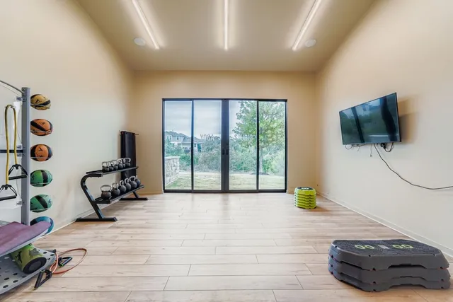 a room with gym equipment and a flat screen tv