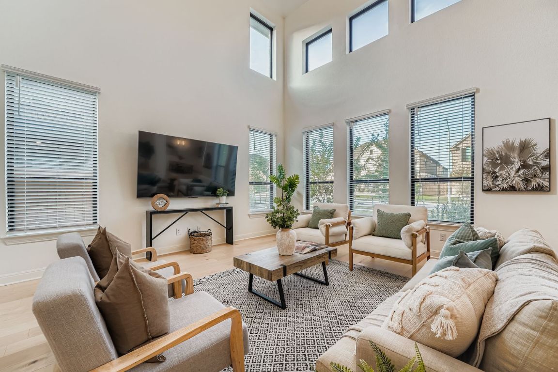 2928 Birdcall Path Leander, TX 78641 - Photo 8 of 36 a living room with furniture and a flat screen tv