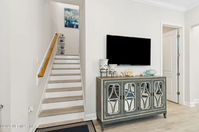 a living room with furniture a clock on wall and a window