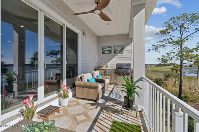 a kitchen with stainless steel appliances kitchen island granite countertop a table chairs and a stove