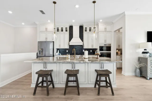 a kitchen with granite countertop a stove a microwave and cabinets