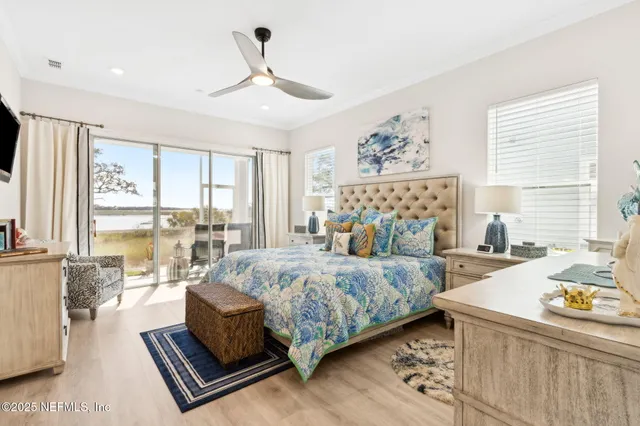 a bedroom with a bed and a painting on the wall