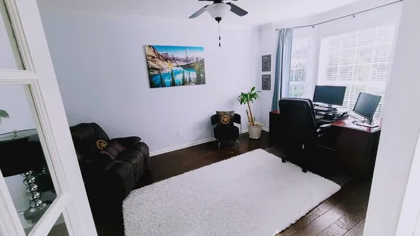 a living room with furniture rug and wooden floor