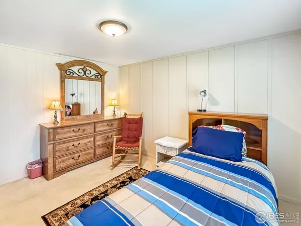 a room with a bed and a dresser