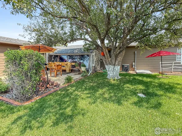 a backyard of a house with table and chairs