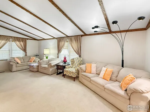 a living room with furniture and a ceiling fan