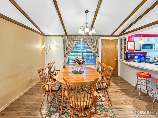 a dining room with furniture and wooden floor