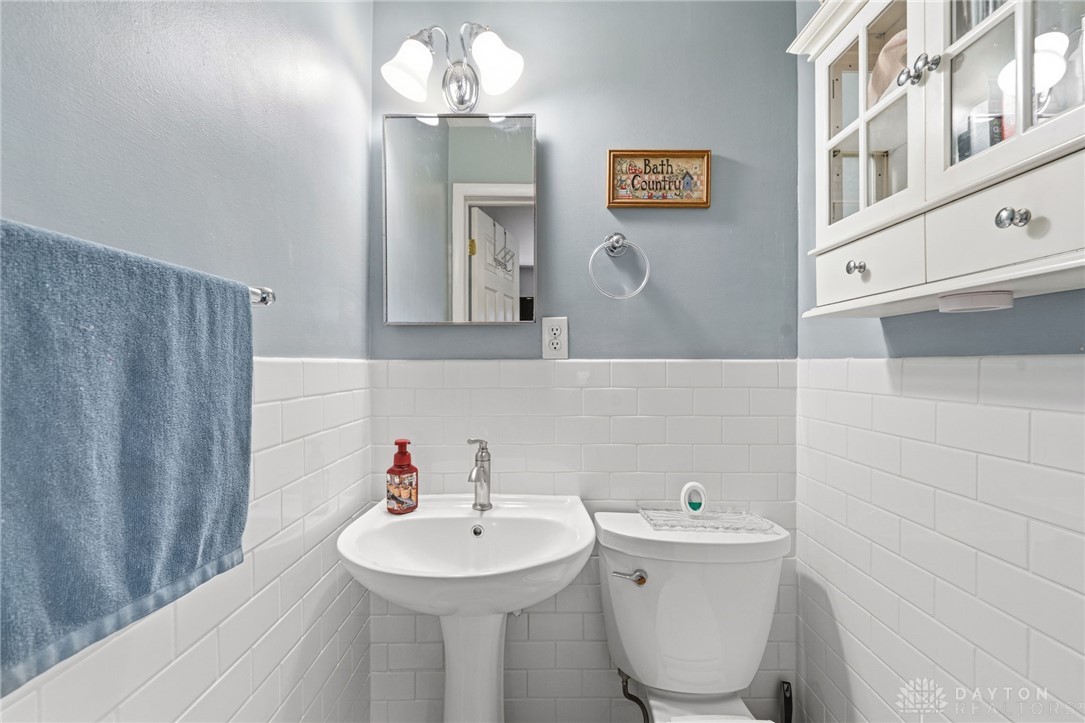 2945 Ashlar Drive Springfield, OH 45503 - Photo 14 of 20 This clean and bright bathroom off primary bedroom features a pedestal sink and classic subway tile.