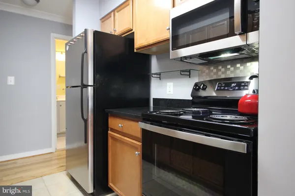 a kitchen with stainless steel appliances granite countertop a refrigerator and a stove