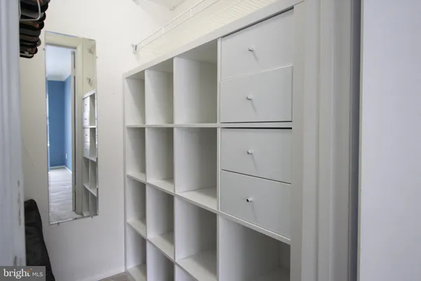 a view of walk in closet with empty racks