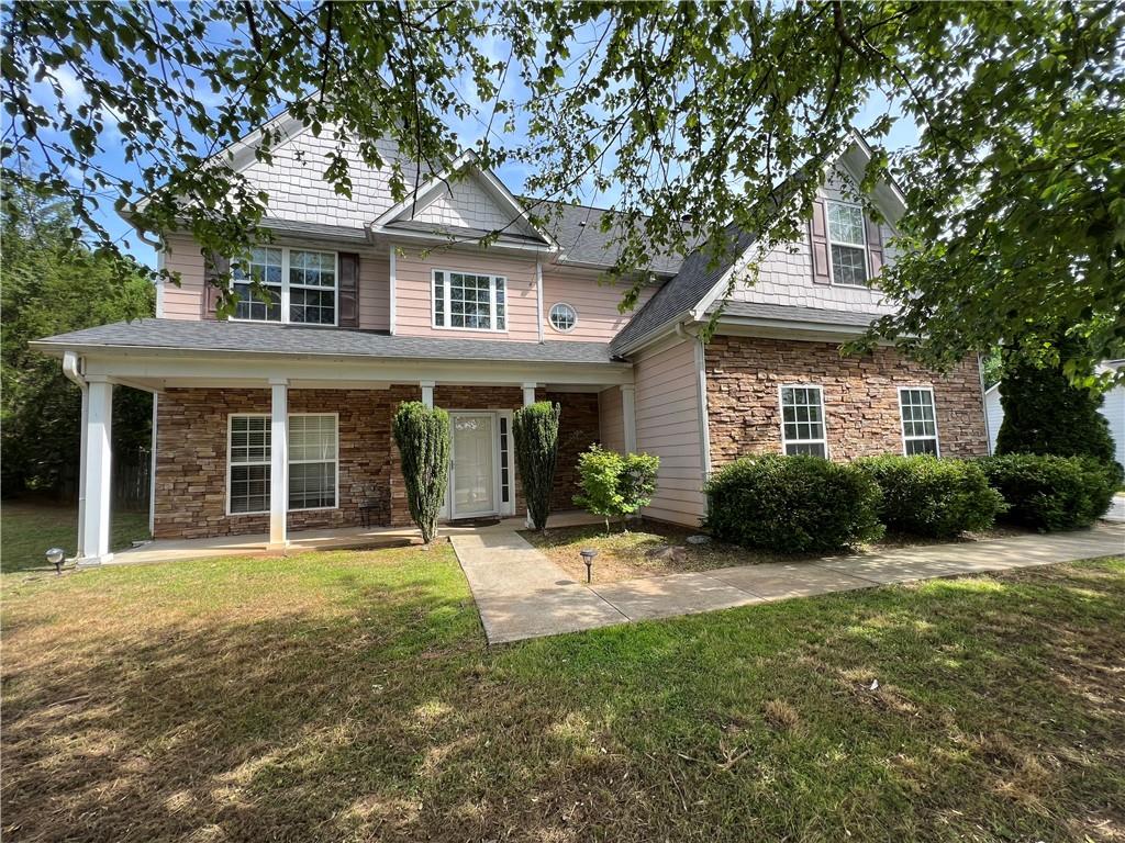 a front view of a house with a yard and porch