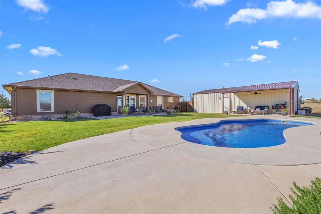 2375 County Road 4010 Decatur, TX 76234 - Photo 27 of 34 View of swimming pool with a patio and an outdoor structure