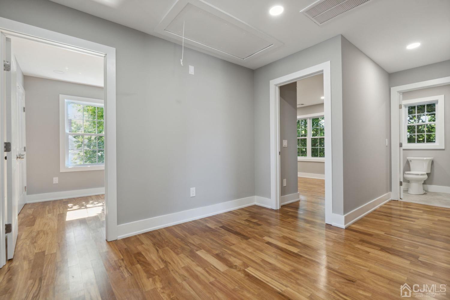 10 Sine Road Edison, NJ 08817 - Photo 3 of 38 an empty room with wooden floor and windows