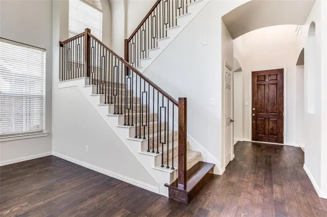 a view of staircase with wooden floor and a window