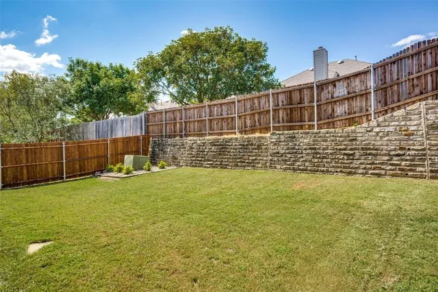 a view of a deck with a big yard and large trees