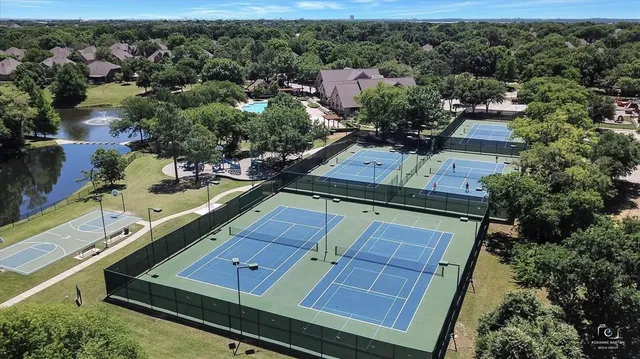 an aerial view of a residential houses with yard