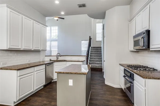 a kitchen that has a sink and a stove in it