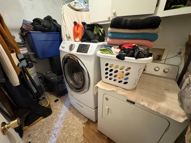 a utility room with dryer washer and other items