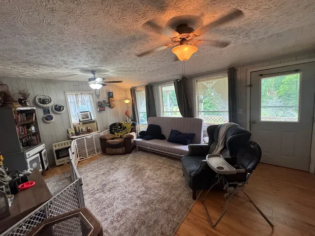 a living room with furniture and a chandelier