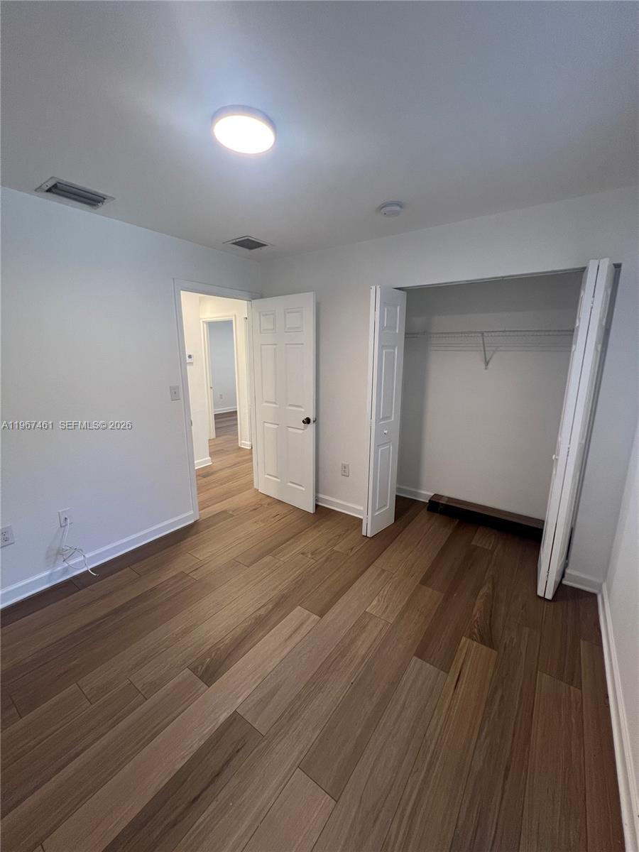 12254 Southwest 217th Street Miami, FL 33170 - Photo 25 of 29 an empty room with wooden floor and windows