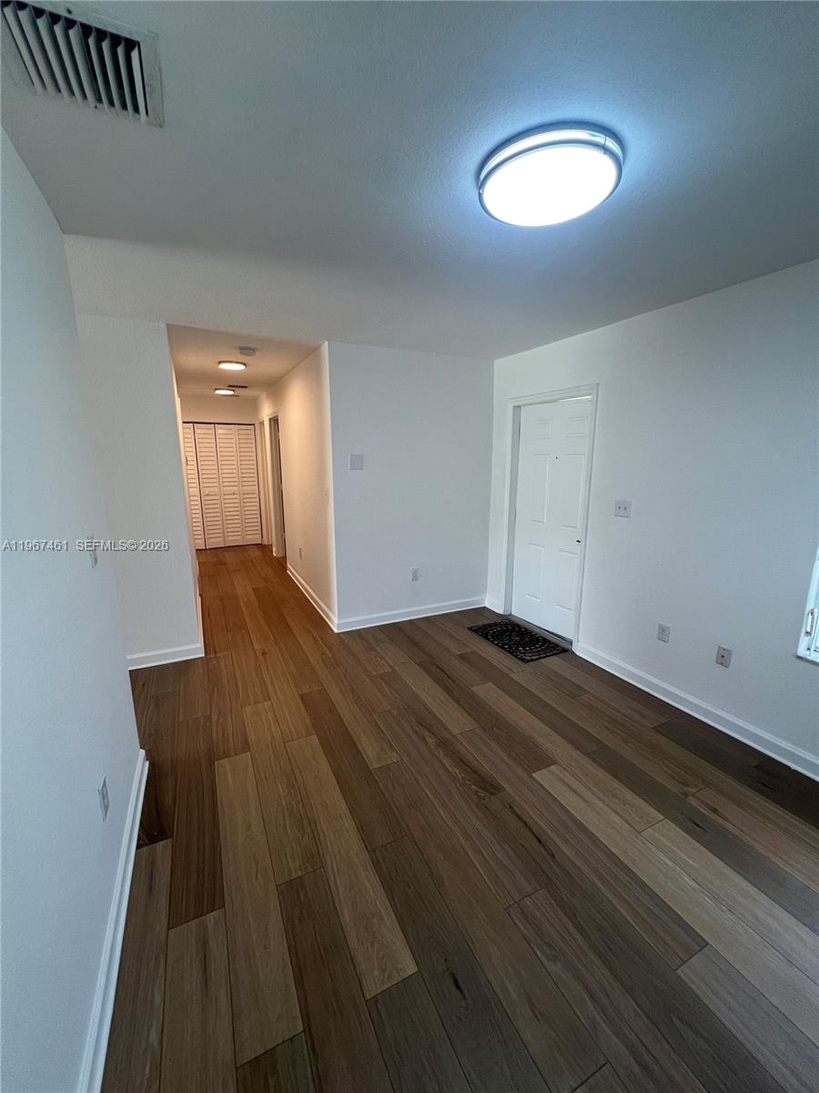 12254 Southwest 217th Street Miami, FL 33170 - Photo 4 of 29 a view of empty room with wooden floor