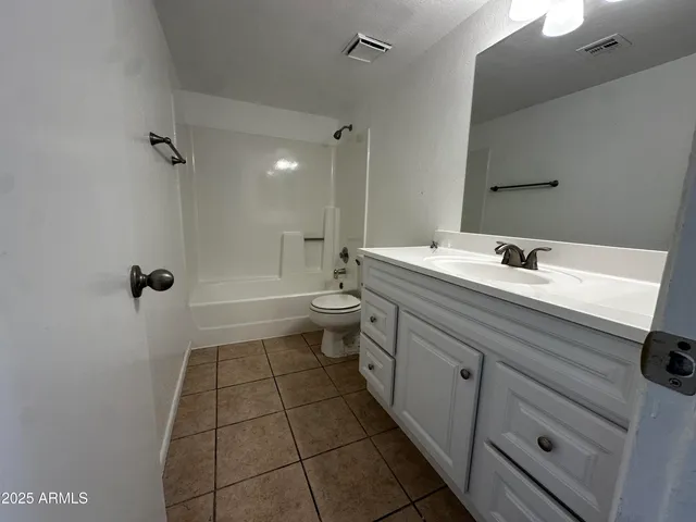 a bathroom with a sink a toilet a mirror and shower