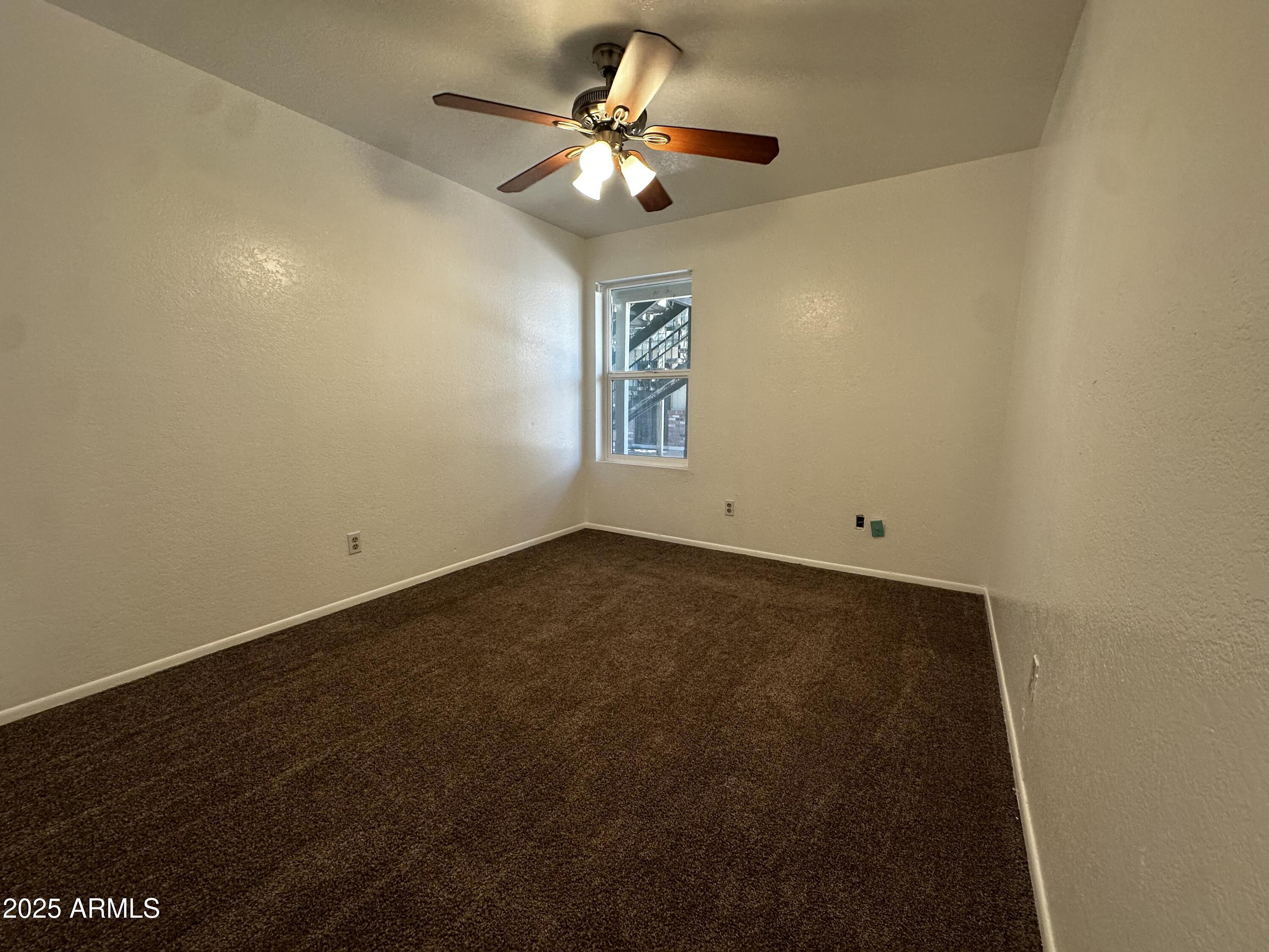 834 North Cherry, Unit 202 Mesa, AZ 85201 - Photo 7 of 9 an empty room with a window and a ceiling fan