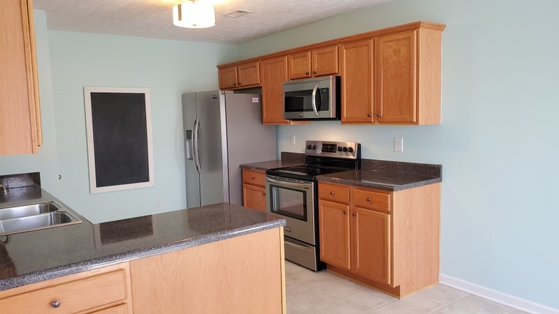 4001 Deer Run Trace Spring Hill, TN 37174 - Photo 2 of 16 a kitchen with stainless steel appliances granite countertop a sink stove and microwave