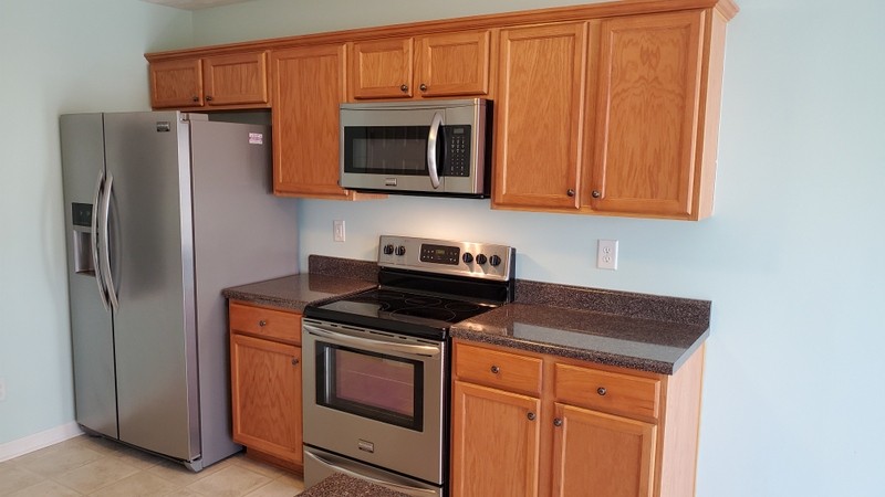 4001 Deer Run Trace Spring Hill, TN 37174 - Photo 4 of 16 a kitchen with stainless steel appliances granite countertop a refrigerator stove and microwave