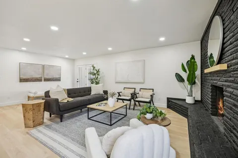 a living room with furniture potted plant and a lamp