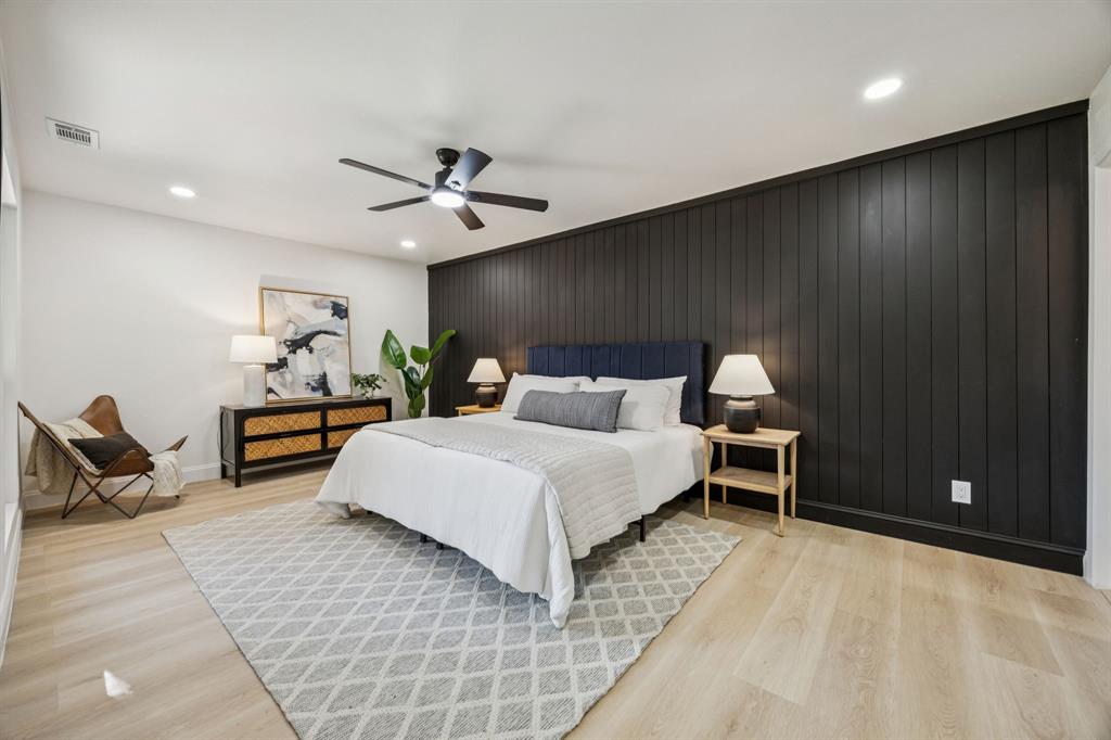 3115 Whirlaway Road Dallas, TX 75229 - Photo 12 of 28 Bedroom with wood walls, light wood-style floors, recessed lighting, and ceiling fan