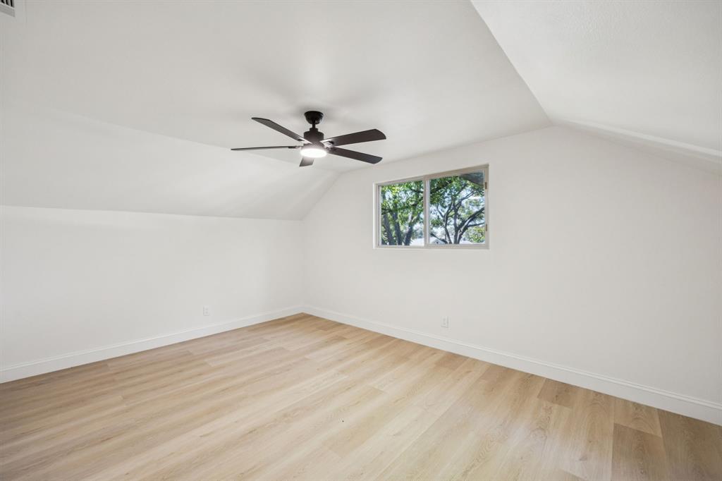 3115 Whirlaway Road Dallas, TX 75229 - Photo 18 of 28 Additional living space with lofted ceiling, light wood-style flooring, and a ceiling fan