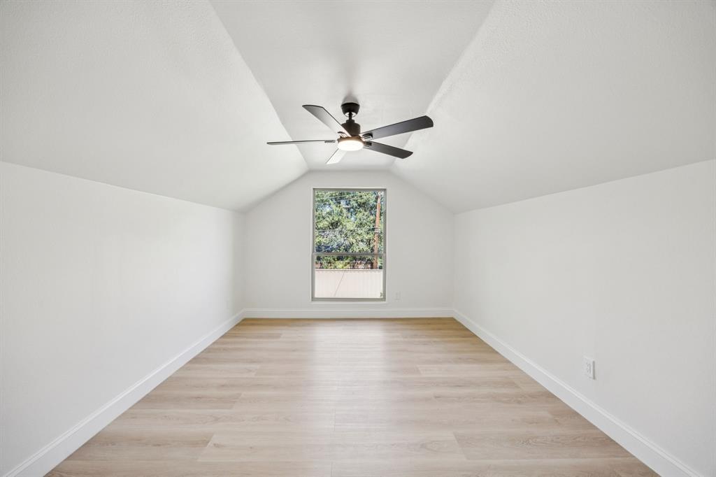 3115 Whirlaway Road Dallas, TX 75229 - Photo 19 of 28 Additional living space with light wood-style floors, vaulted ceiling, and a ceiling fan