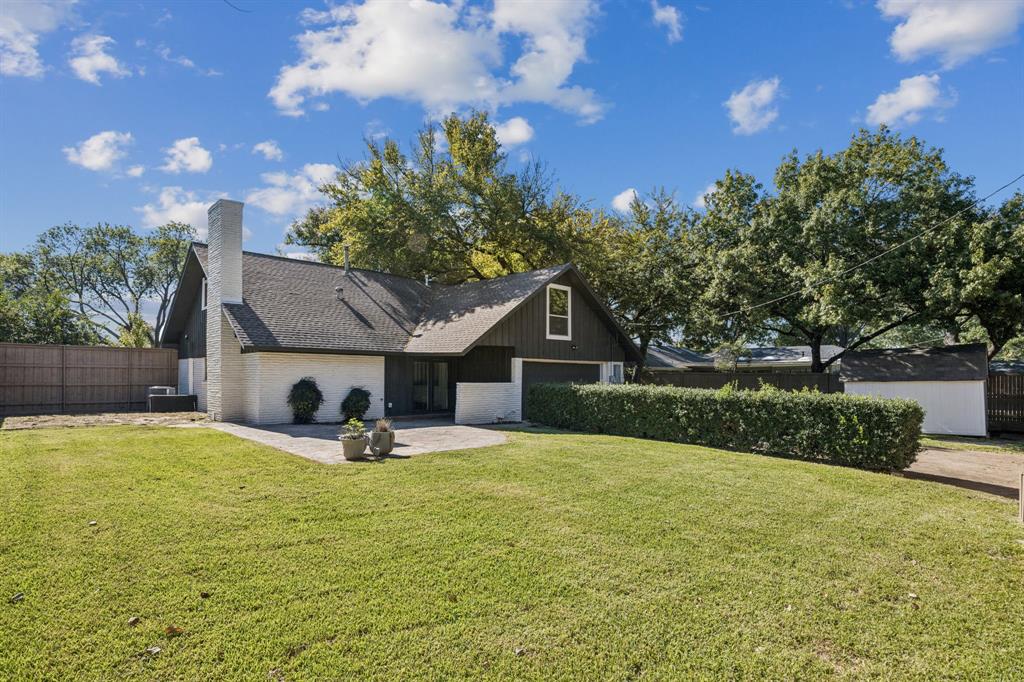 3115 Whirlaway Road Dallas, TX 75229 - Photo 22 of 28 View of front of house featuring brick siding, a chimney, a shingled roof, and a patio area