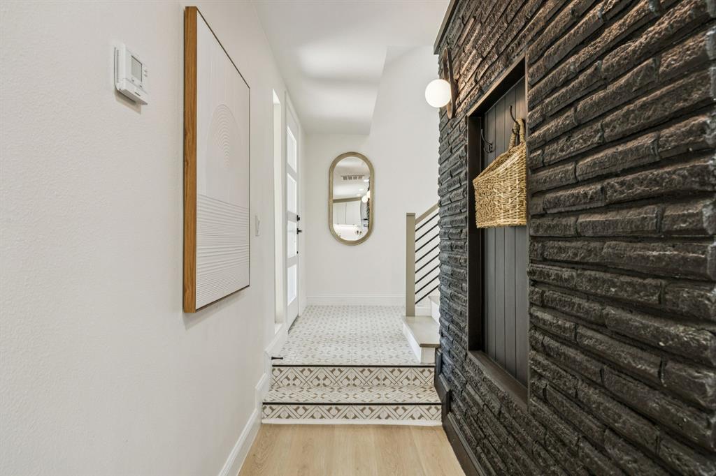 3115 Whirlaway Road Dallas, TX 75229 - Photo 3 of 28 Hallway with light wood finished floors and baseboards