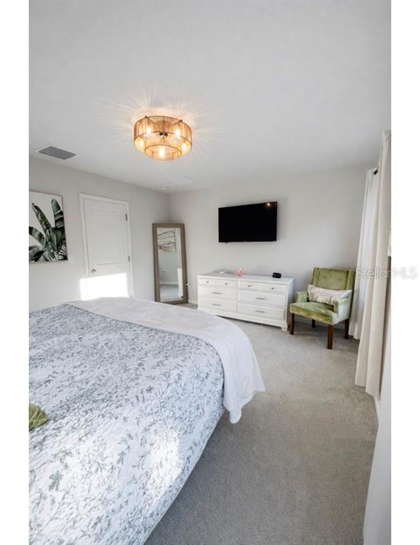 3109 Victoria Inlet Drive Holiday, FL 34691 - Photo 18 of 23 a bedroom with a bed and a television