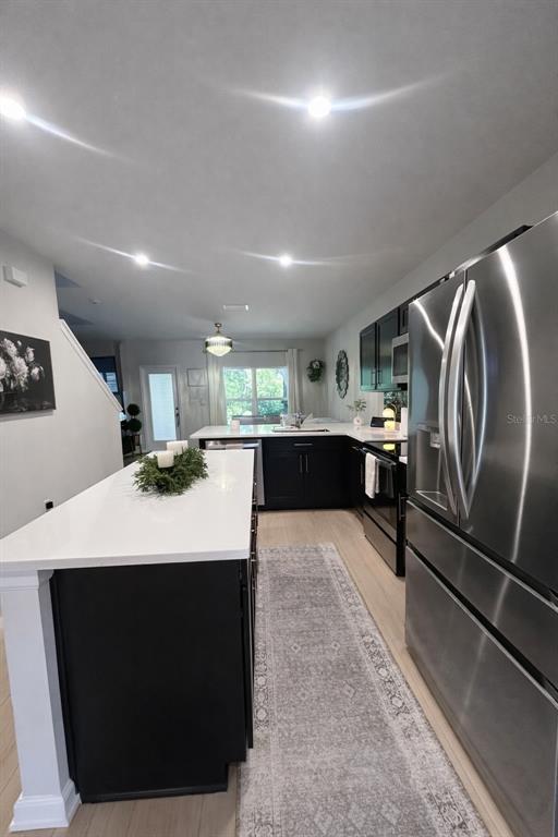 3109 Victoria Inlet Drive Holiday, FL 34691 - Photo 7 of 23 a large white kitchen with a sink a washer and dryer