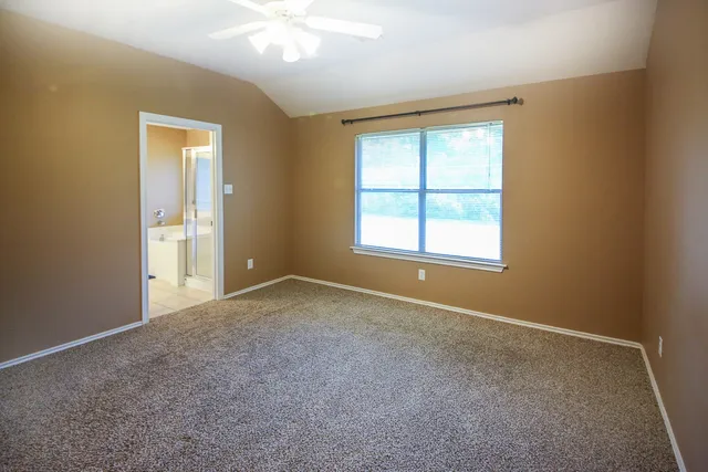 an empty room with windows and closet