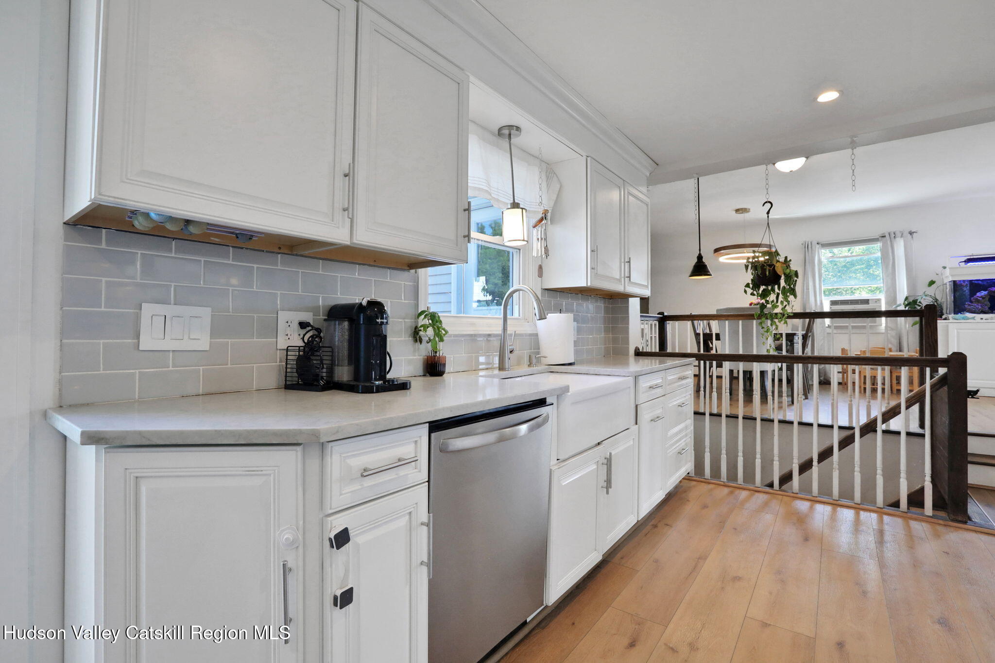 2294 Highway 32 Saugerties, NY 12477 - Photo 14 of 36 a kitchen with white cabinets a sink dishwasher and a stove with wooden floor