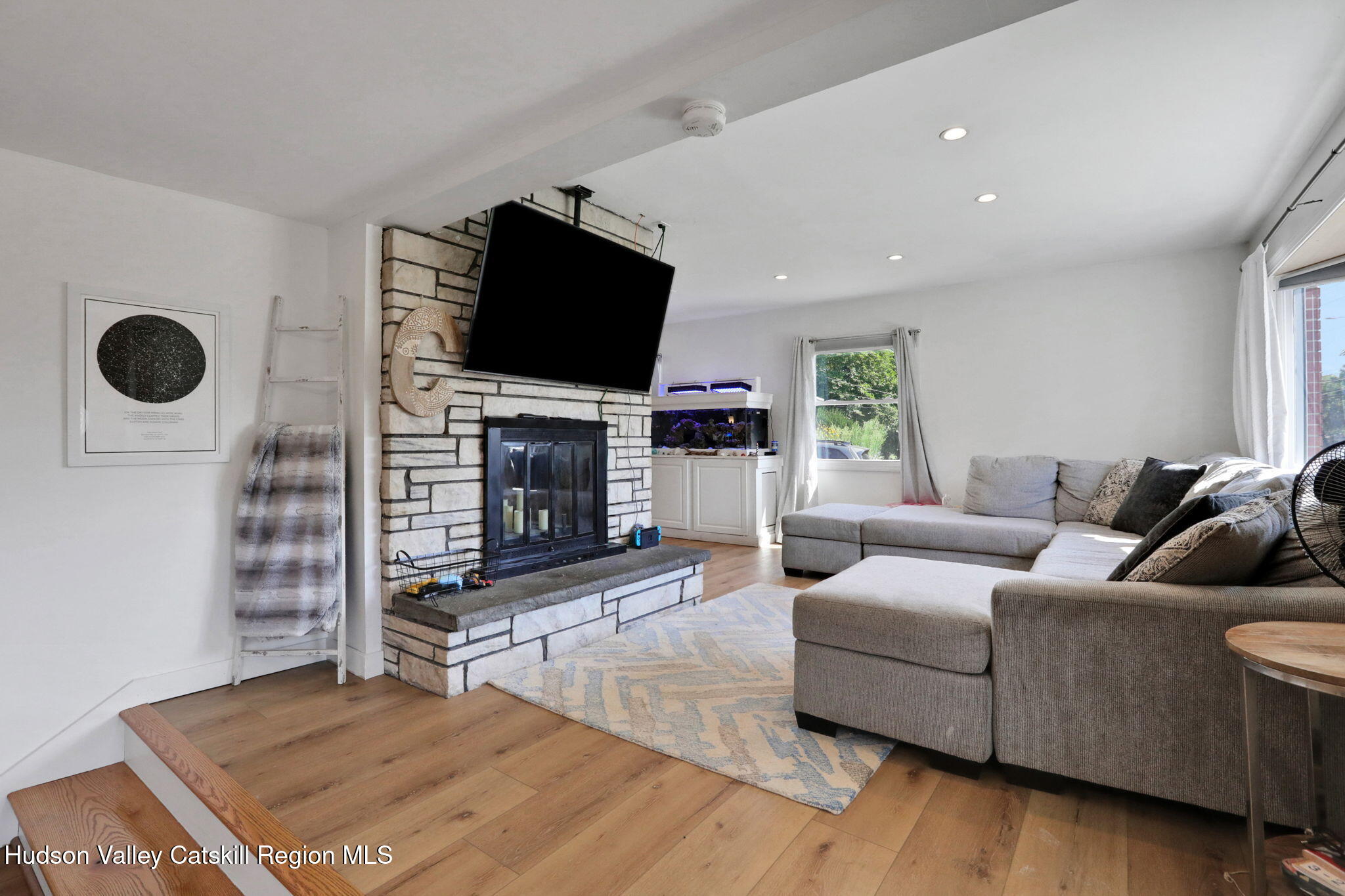 2294 Highway 32 Saugerties, NY 12477 - Photo 4 of 36 a living room with furniture a flat screen tv and a fireplace