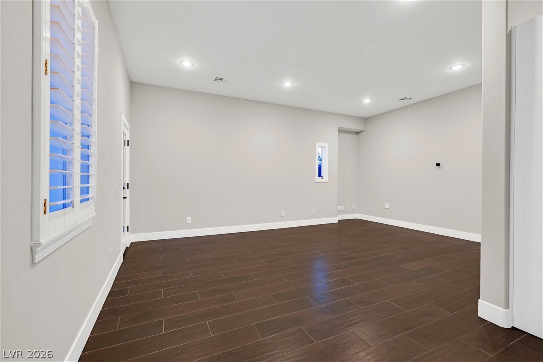 6 Rue Du Ville Henderson, NV 89011 - Photo 49 of 99 Bright and airy living area featuring rich hardwood flooring and elegant recessed lighting.