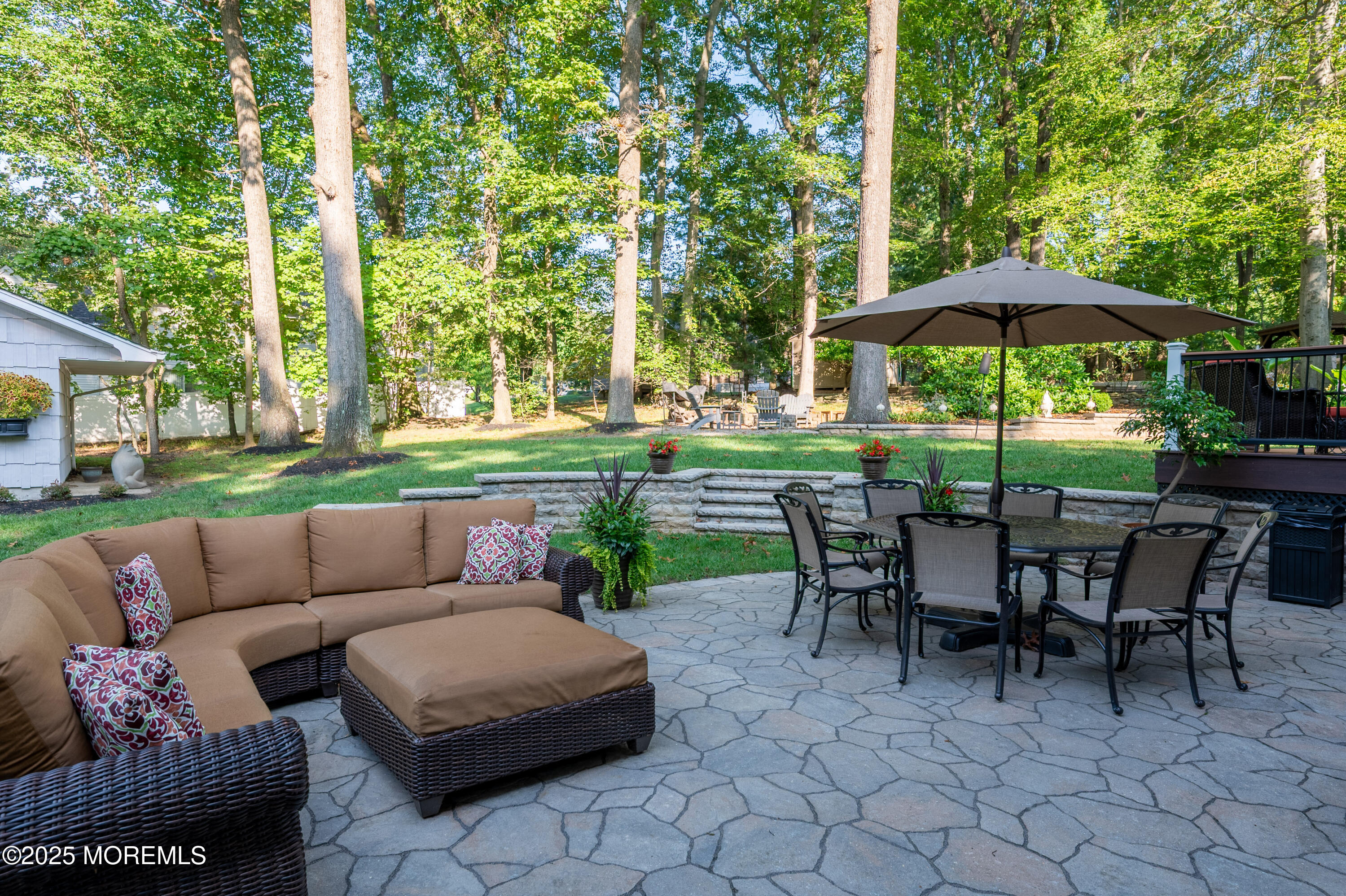 24 Princeton Street Red Bank, NJ 07701 - Photo 33 of 37 a view of a patio with couches and table and chairs under an umbrella