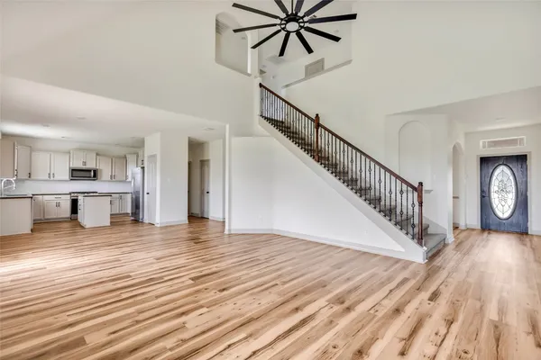 a view of an empty room and wooden floor