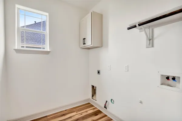 a view of small space with wooden floor and cabinet