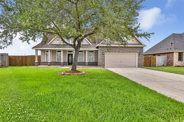 a front view of house with yard and green space