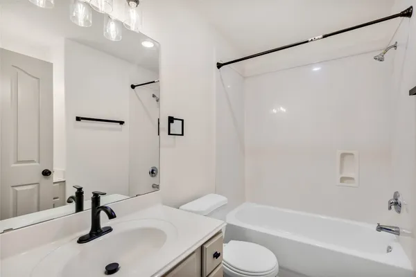 a bathroom with a sink a toilet and a bathtub